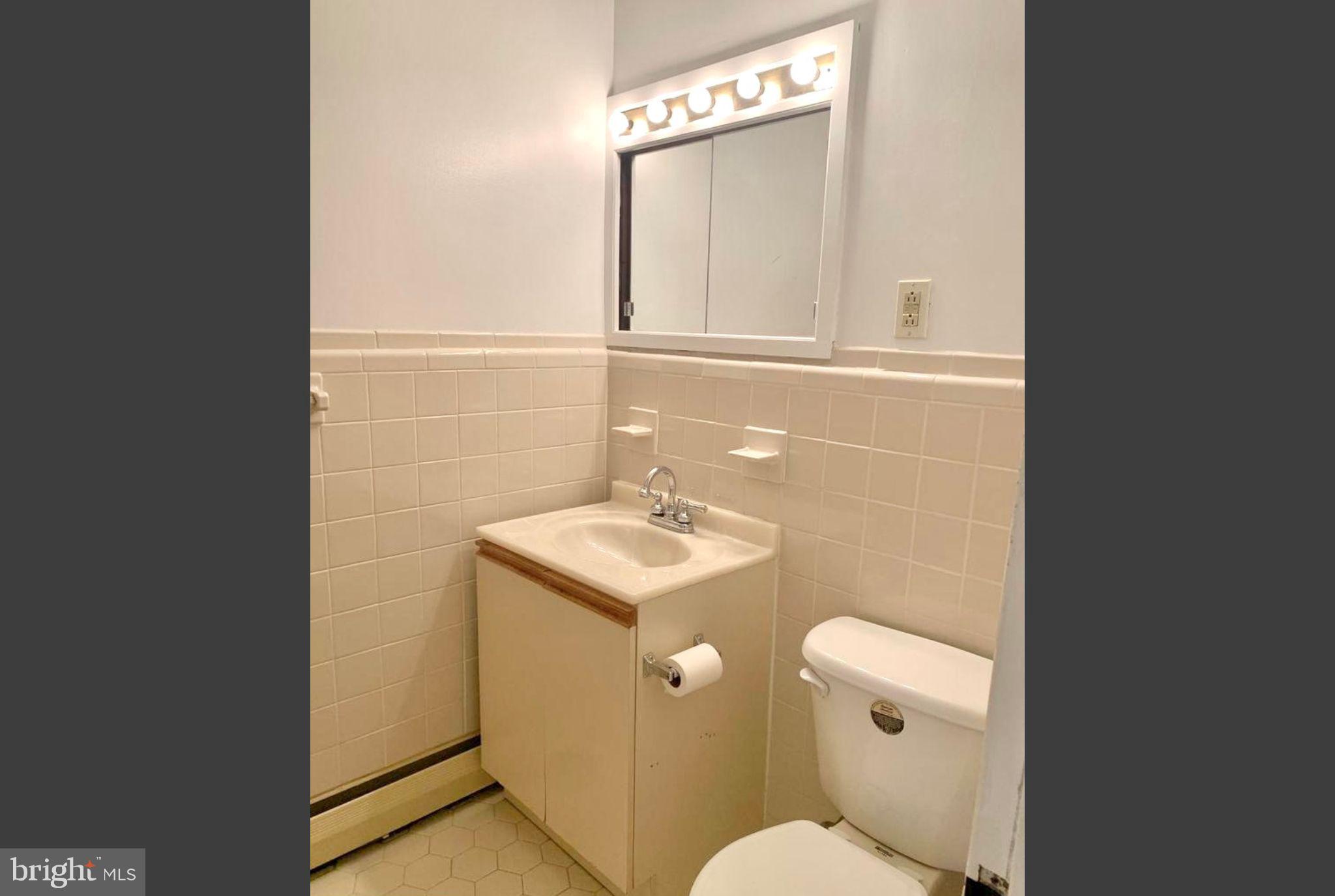 383 Lakeside Road, Unit 104 Ardmore, PA 19003 - Photo 11 of 18 a bathroom with a sink a toilet and mirror