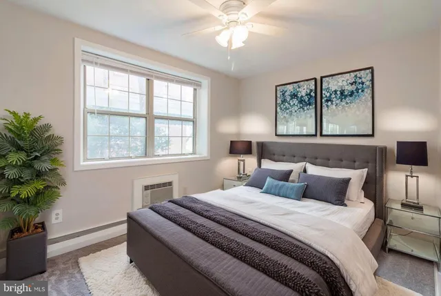 a bedroom with bed and a potted plant