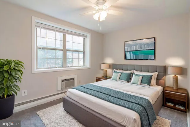 a bedroom with a bed and a potted plant