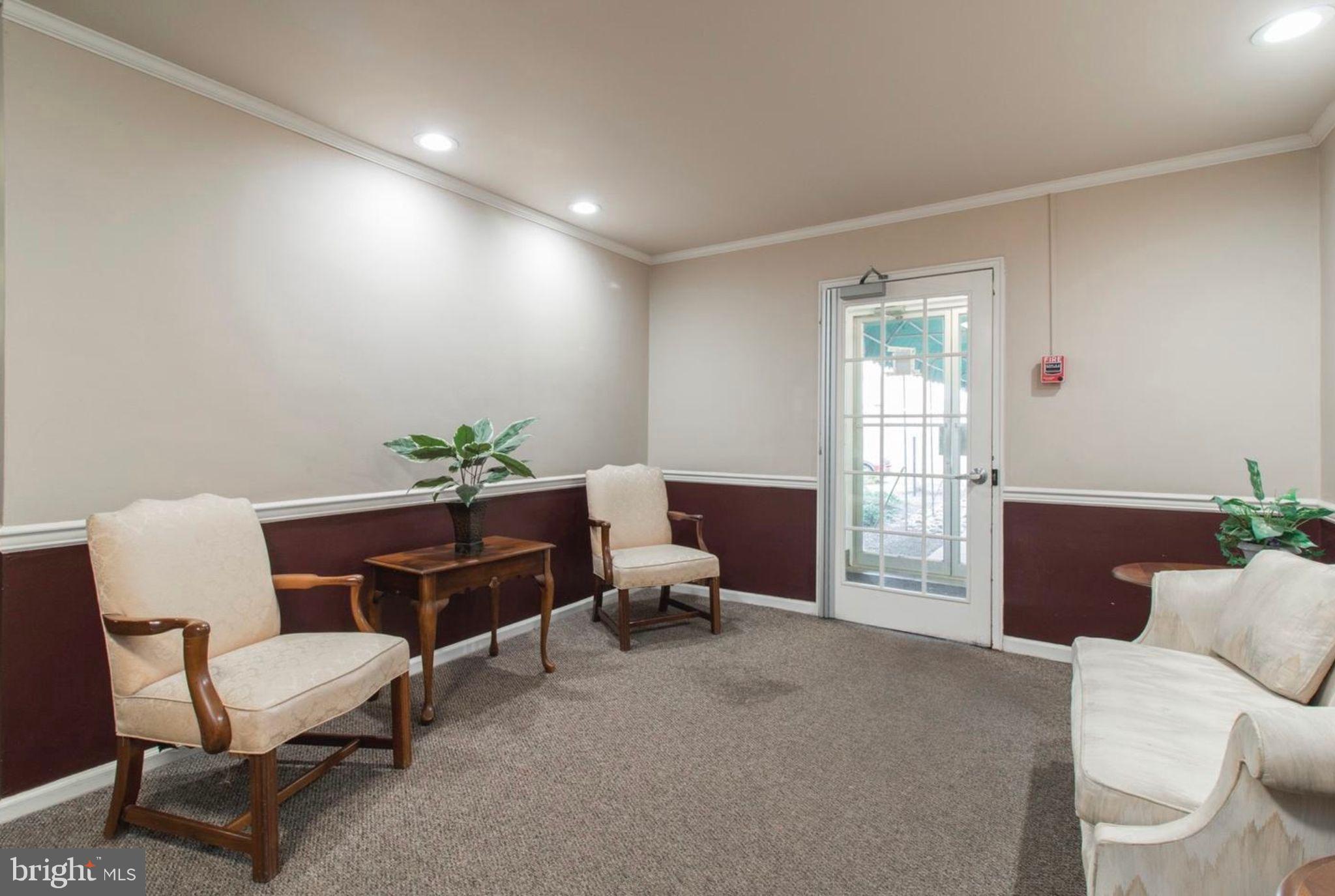 383 Lakeside Road, Unit 104 Ardmore, PA 19003 - Photo 7 of 18 a living room with furniture and a window