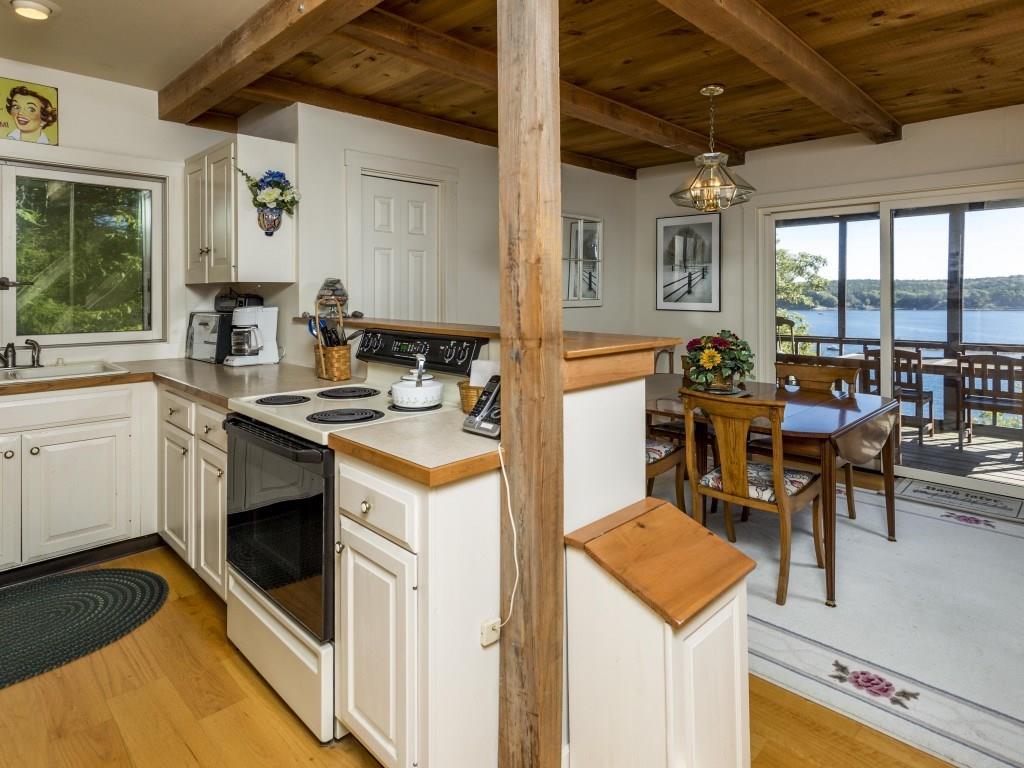 127 Appalachee Road Boothbay Harbor, ME 04538 - Photo 8 of 35 The kitchen with wood cabinets above...