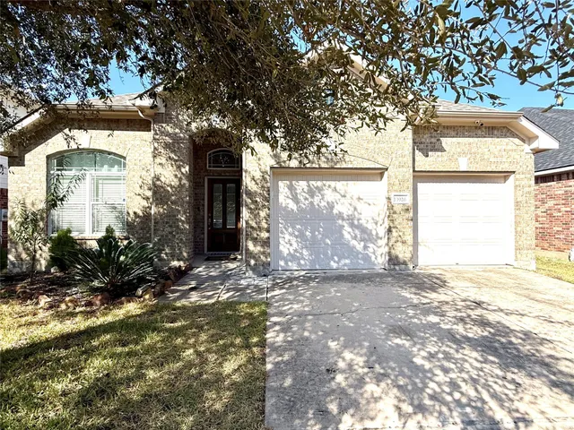 a front view of a house with a yard garage and outdoor seating