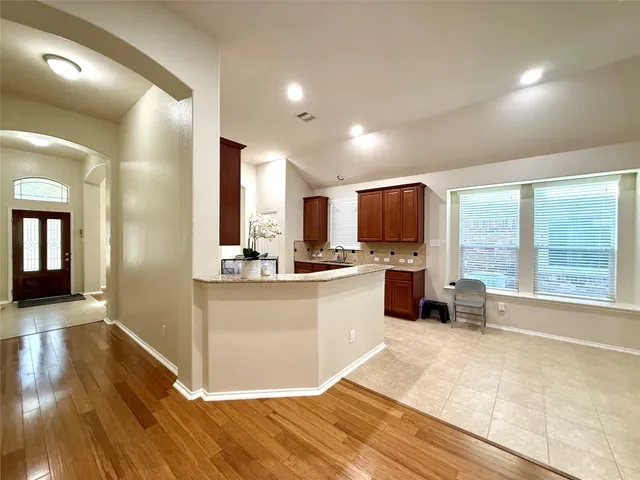 a large white kitchen with a large window