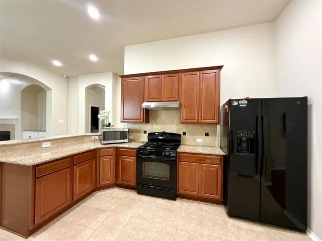 a kitchen with a sink a stove and refrigerator