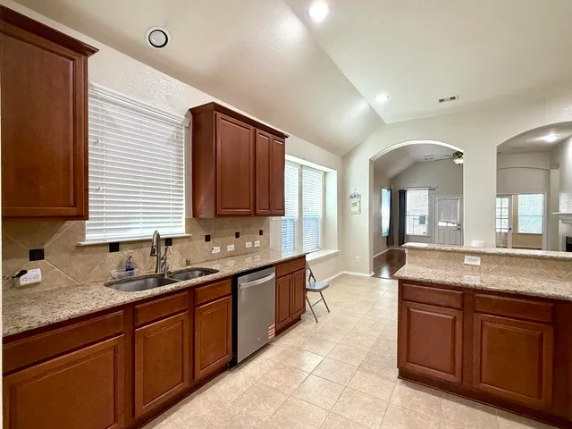 a spacious bathroom with a granite countertop sink and mirror
