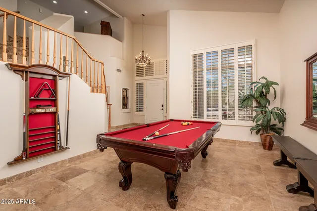 a room with pool table windows and furniture