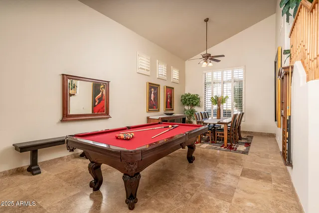 a room with pool table and windows