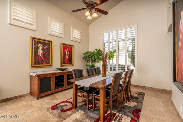 a view of a dining room with furniture and a chandelier
