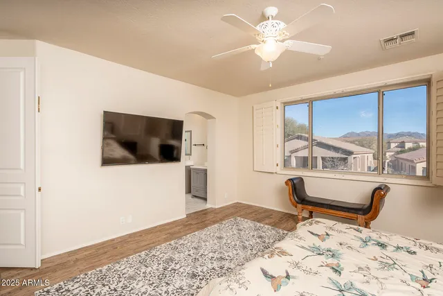 a living room with a bed furniture and a flat screen tv