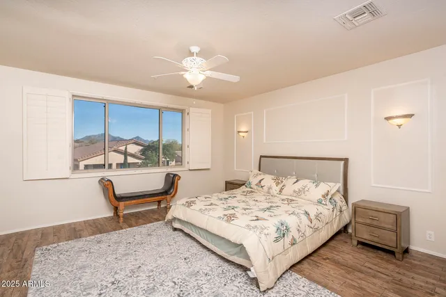 a bed room with a bed and a chair