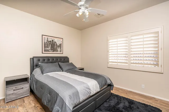 a bedroom with a large bed and a window