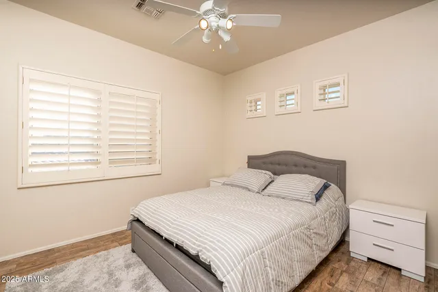 a bedroom with a large bed and a window
