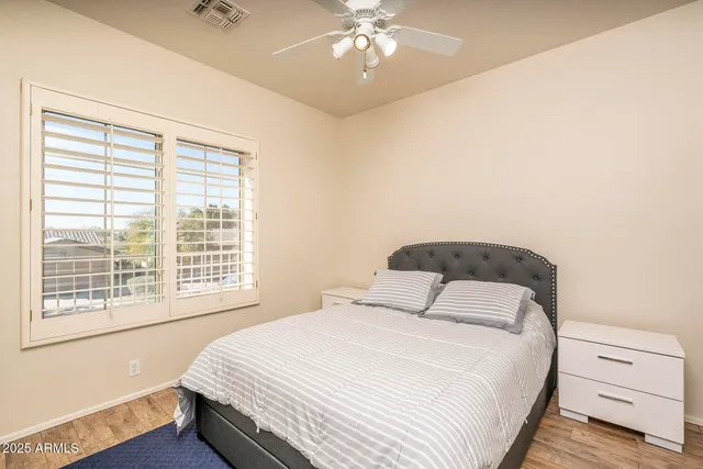 a bedroom with a large bed and a chandelier