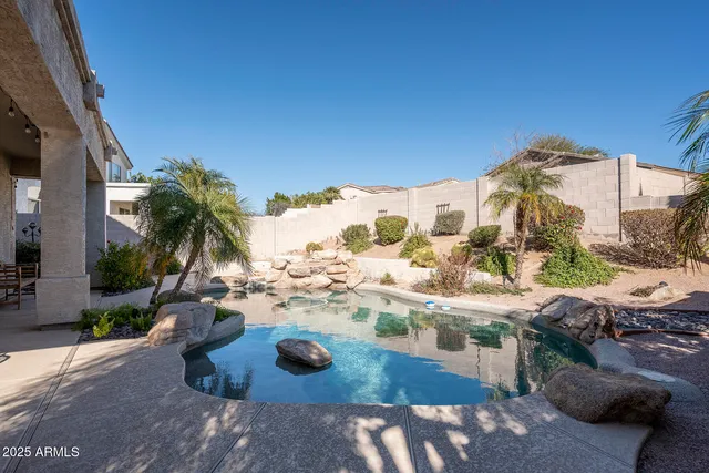 a view of swimming pool with outdoor seating and city view