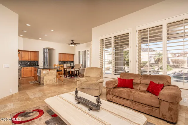 a living room with furniture and floor to ceiling windows
