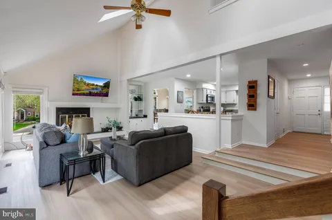 a living room with furniture a fireplace and a large window
