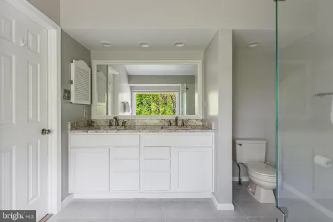 a bathroom with a bathtub next to a window