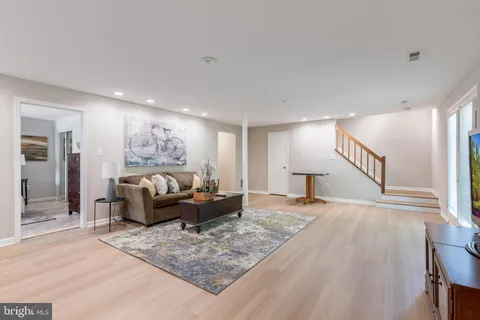 a bedroom with a bed dresser and a window