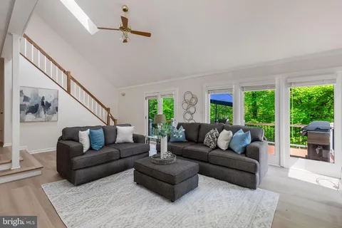 a living room with furniture a large window and a fireplace