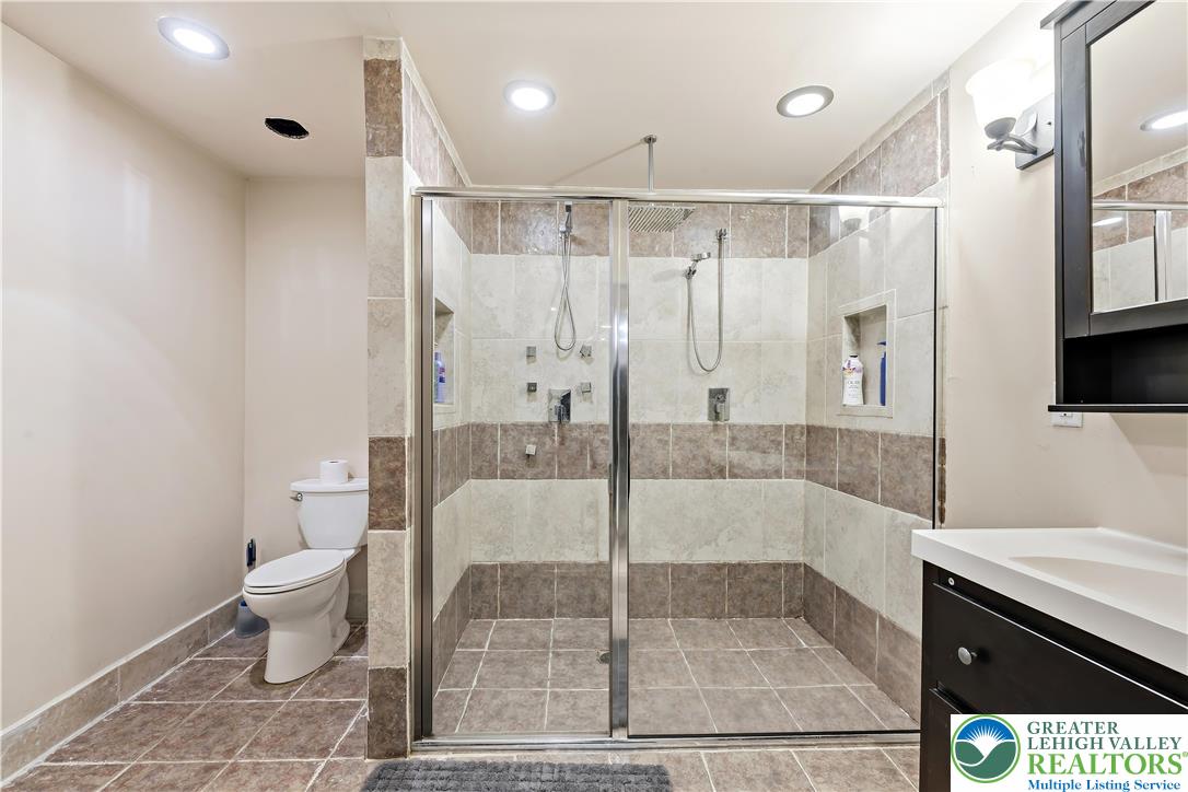 130 Lower Way Road Easton, PA 18045 - Photo 40 of 56 a bathroom with a granite countertop sink a toilet a mirror and shower