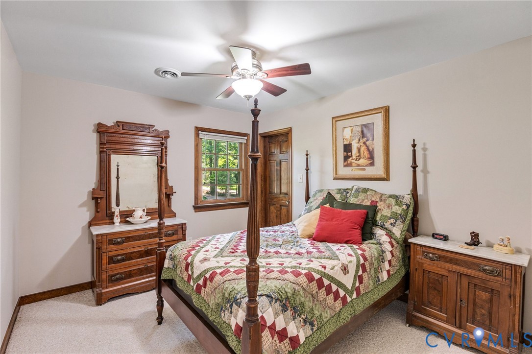 5700 Elfinwood Road Chester, VA 23831 - Photo 28 of 38 a bedroom with a bed and a chandelier