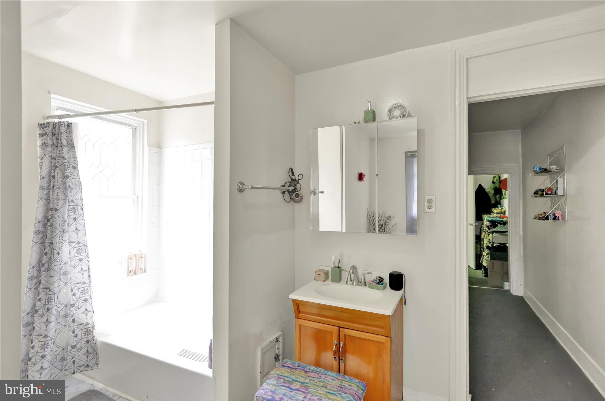 407 South 7th Street Reading, PA 19602 - Photo 25 of 36 a bathroom with a sink mirror and shower
