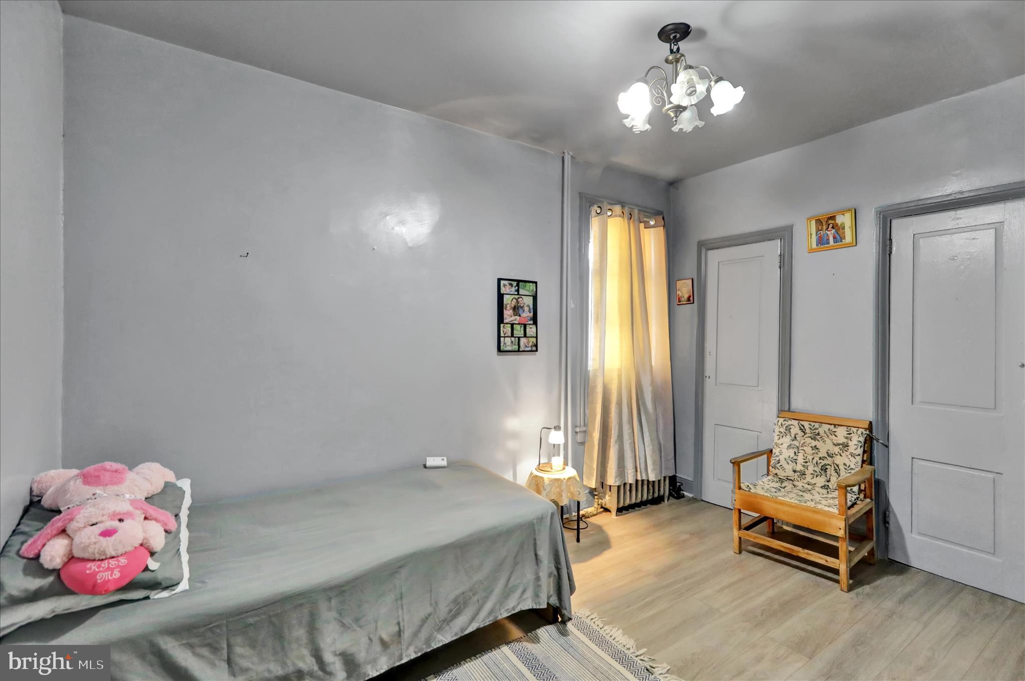 407 South 7th Street Reading, PA 19602 - Photo 27 of 36 a bedroom with a bed and a chandelier
