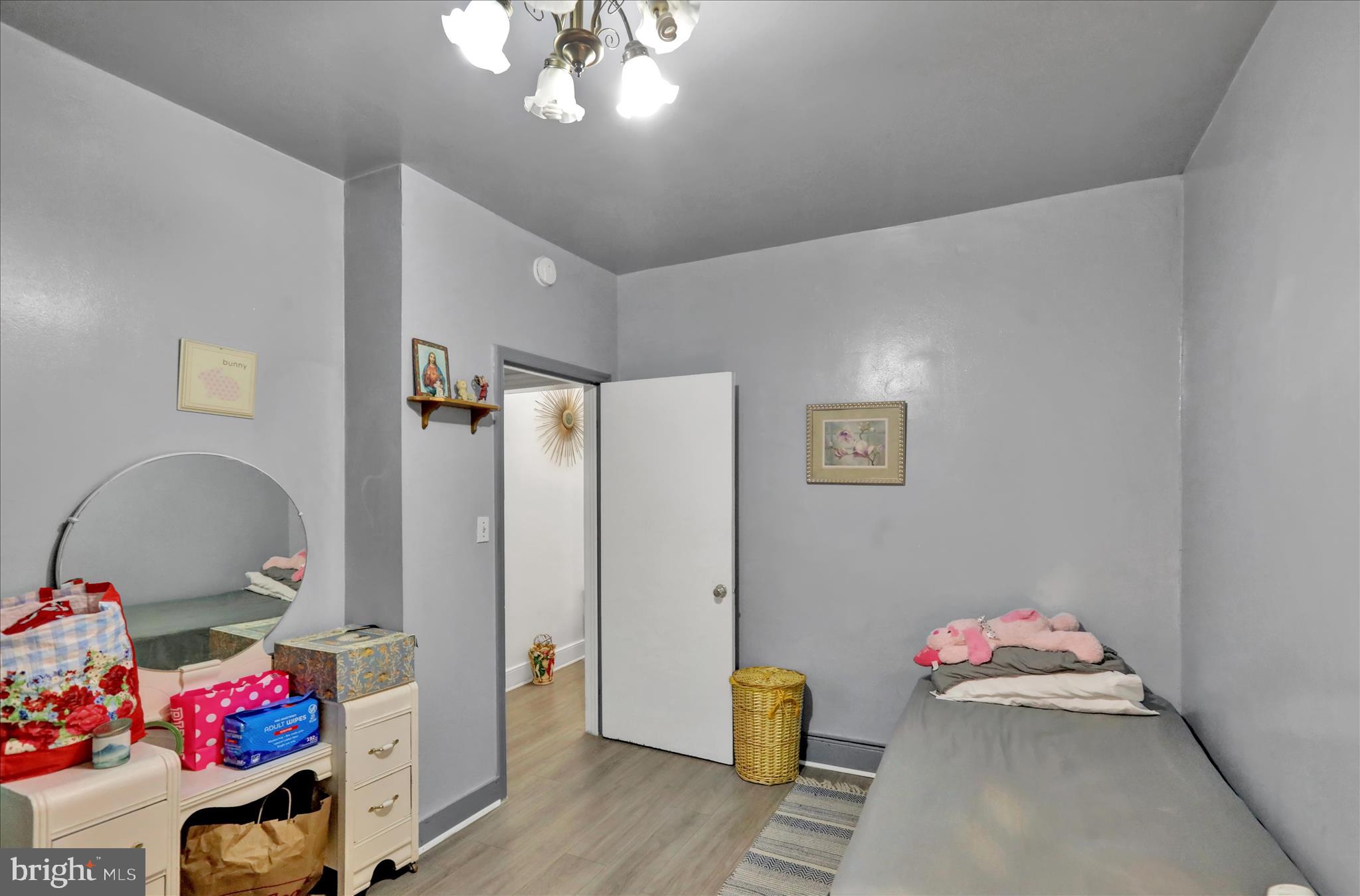 407 South 7th Street Reading, PA 19602 - Photo 28 of 36 a bedroom with a bed and wooden floor