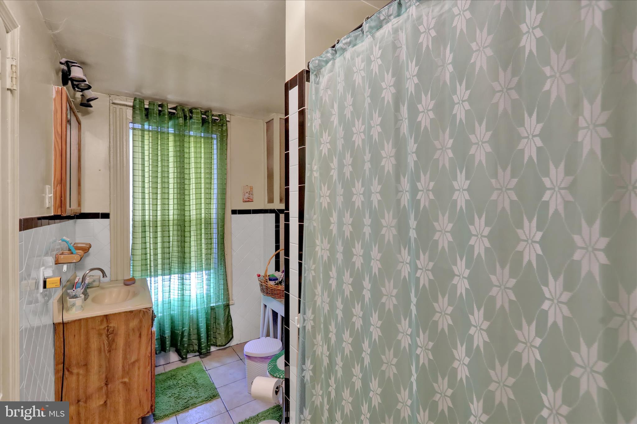 407 South 7th Street Reading, PA 19602 - Photo 30 of 36 a bathroom with a shower curtain and a sink