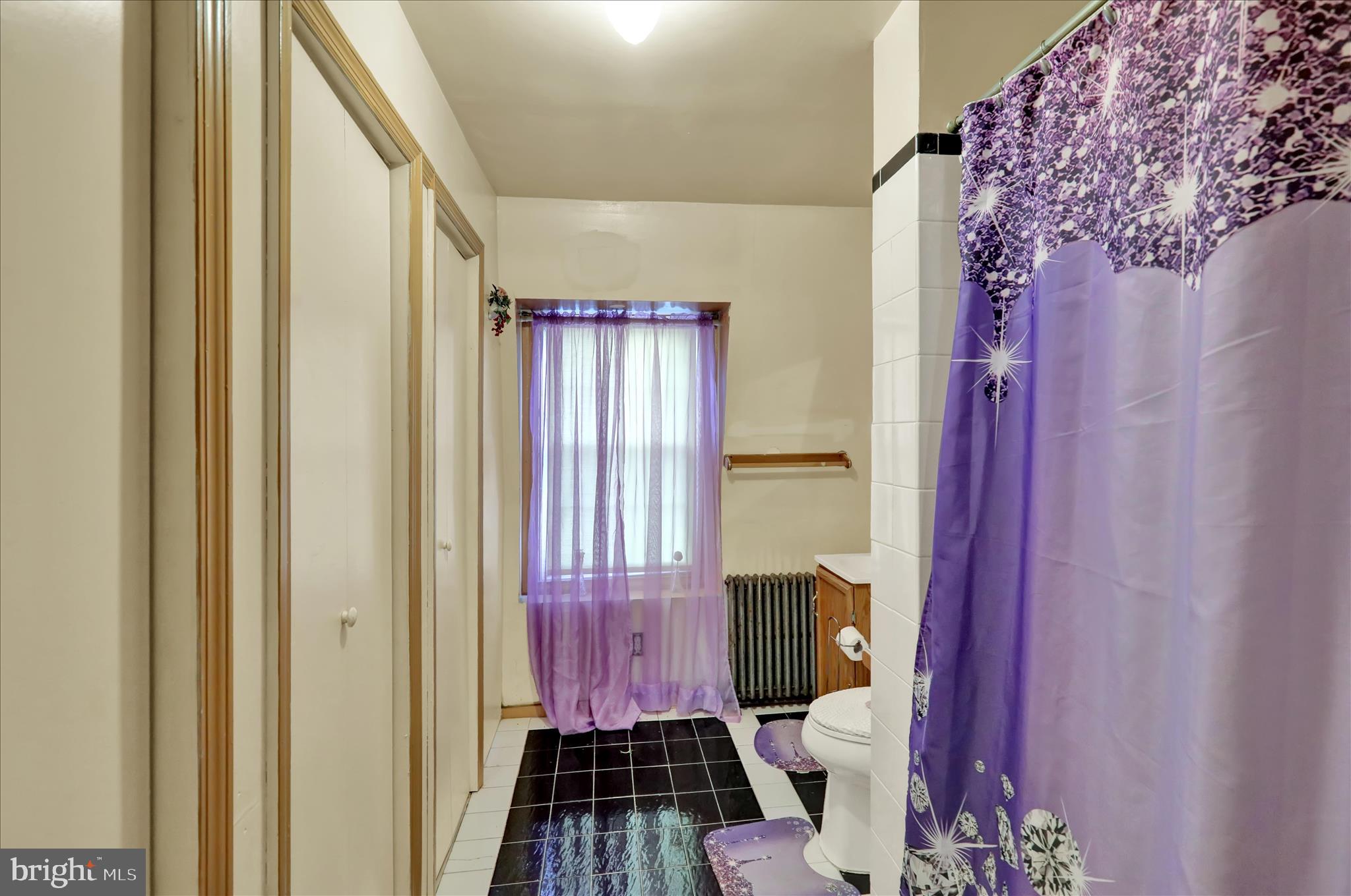 407 South 7th Street Reading, PA 19602 - Photo 32 of 36 a view of a hallway with wooden floor and a bathroom