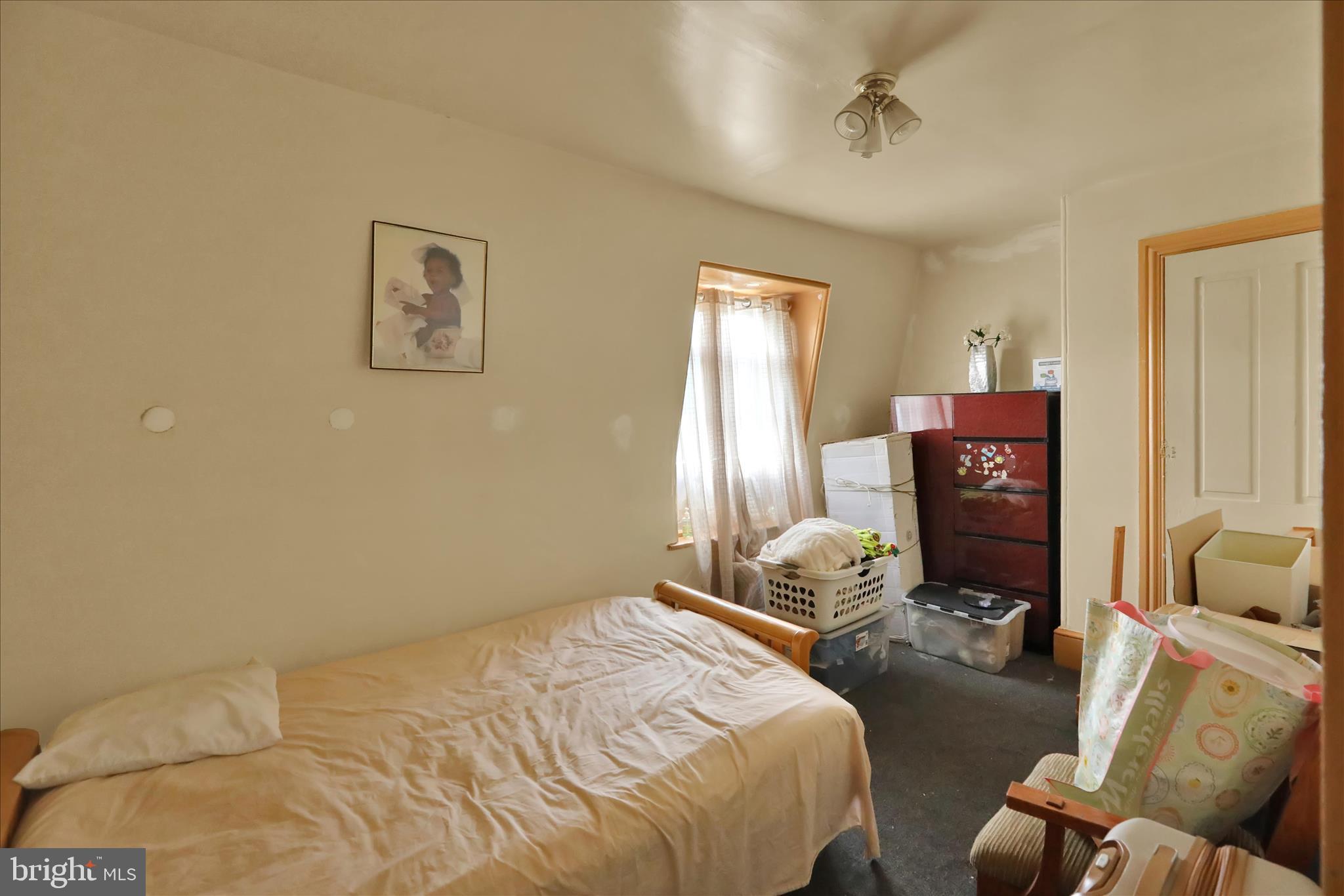 407 South 7th Street Reading, PA 19602 - Photo 33 of 36 a bedroom with a bed and wooden floor