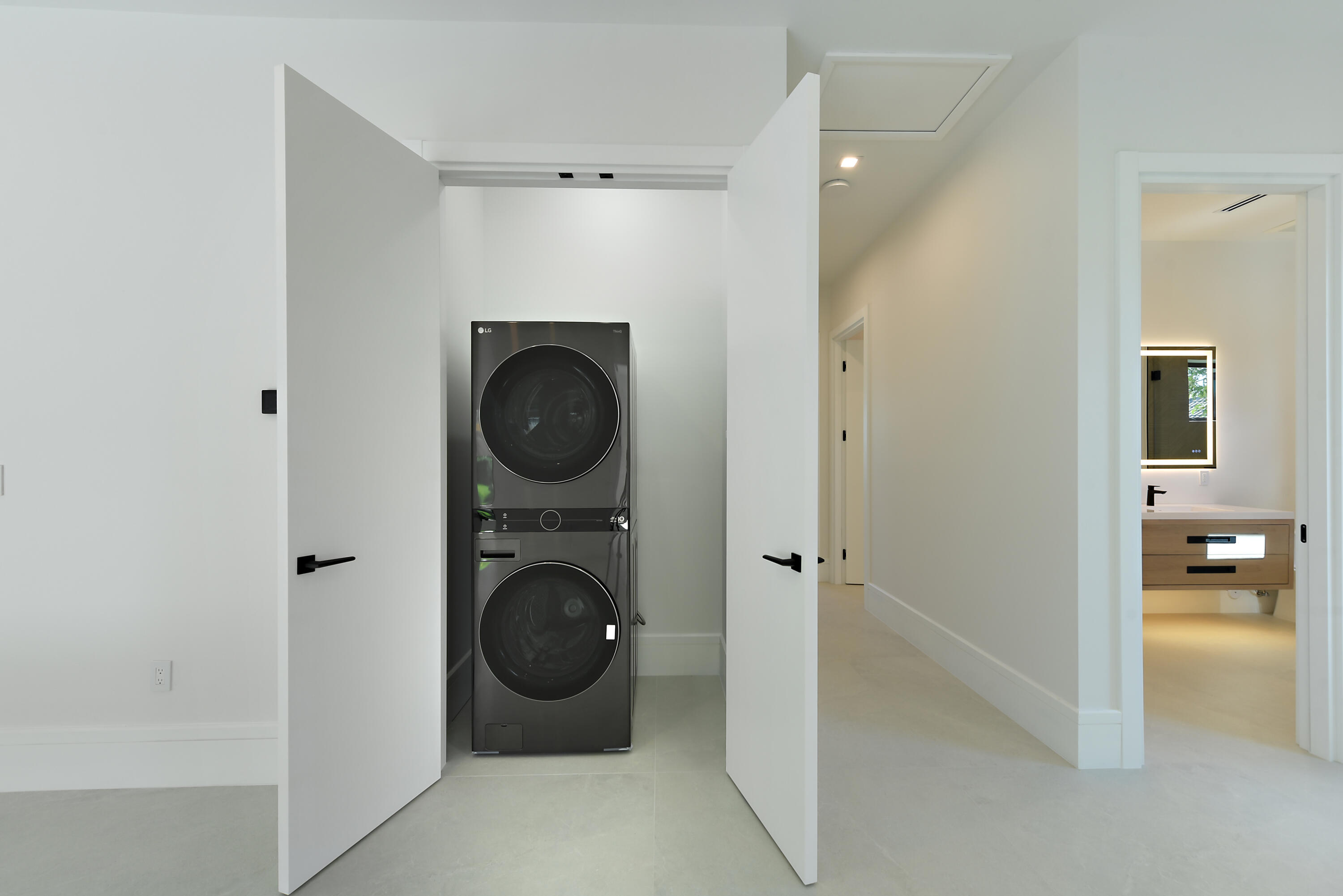17577 Scarsdale Way Boca Raton, FL 33496 - Photo 56 of 145 a view of a hallway with washer and dryer
