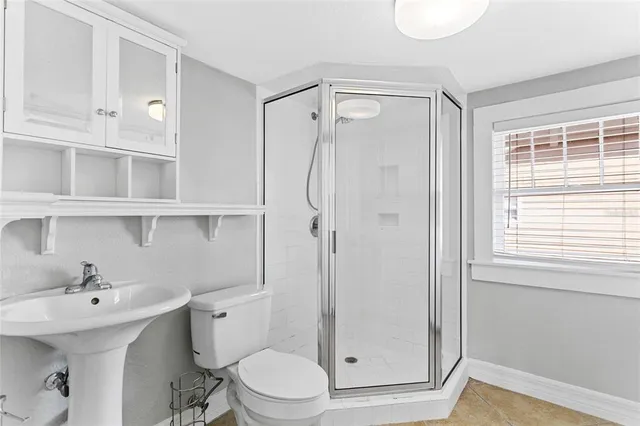 a kitchen with white cabinets and a window