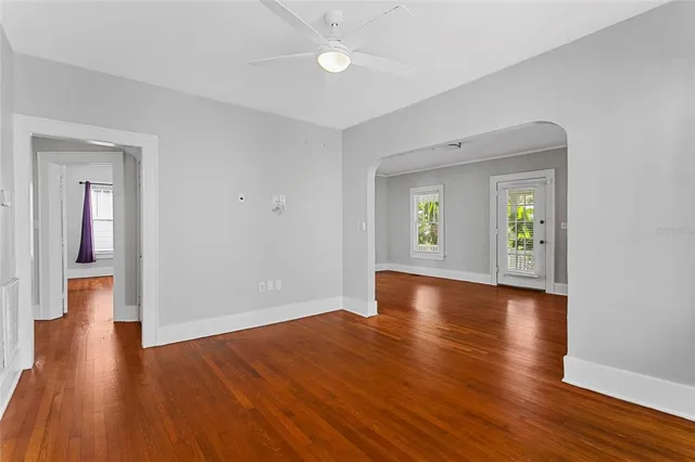 a view of hallway with livingroom and wooden floor