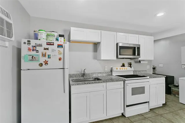 a spacious bedroom with a bed and a window