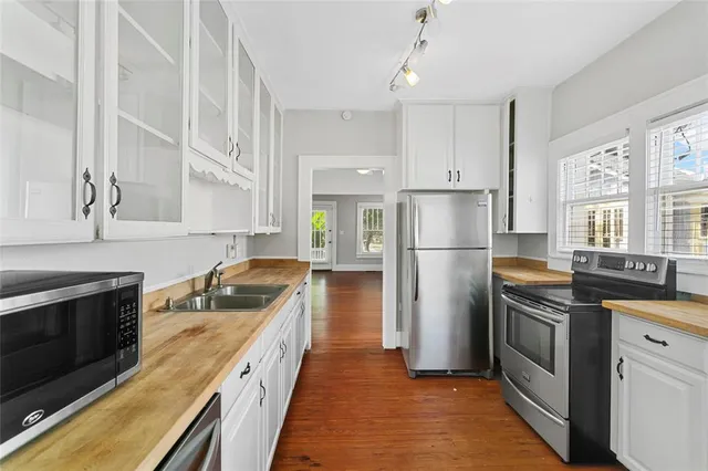 a kitchen with stainless steel appliances granite countertop a sink and dishwasher with wooden floor