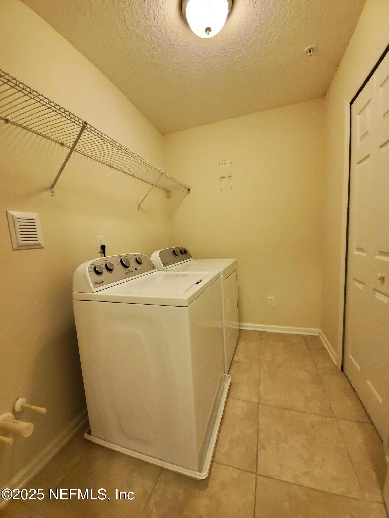 13 La Paz Way St. Augustine, FL 32092 - Photo 11 of 24 a utility room with dryer and washer