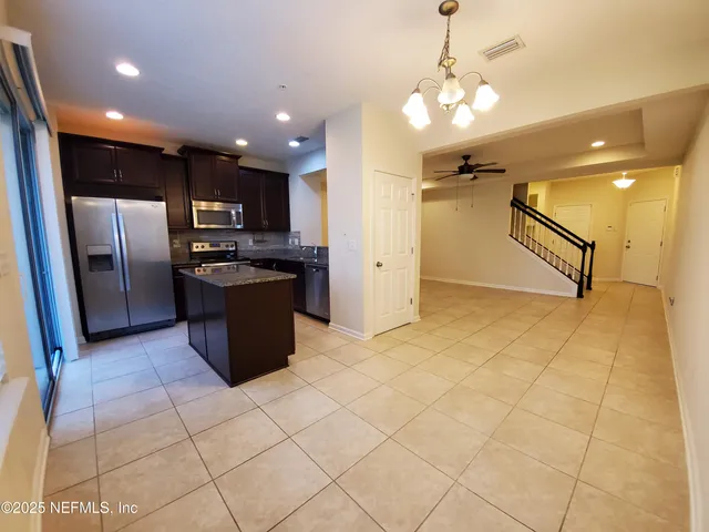 a kitchen with stainless steel appliances granite countertop a refrigerator and a sink
