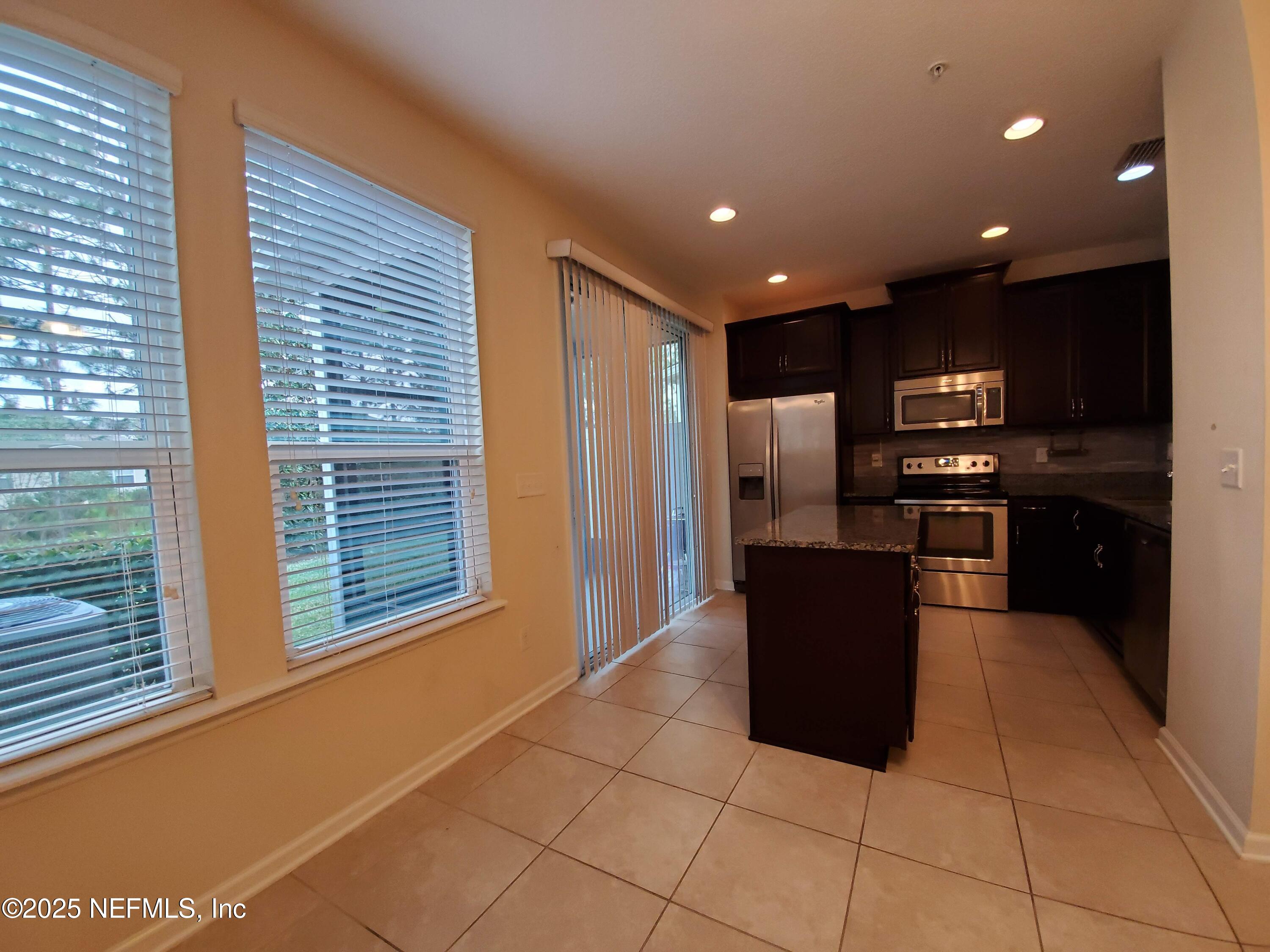13 La Paz Way St. Augustine, FL 32092 - Photo 2 of 24 a kitchen with stainless steel appliances granite countertop a refrigerator and a sink
