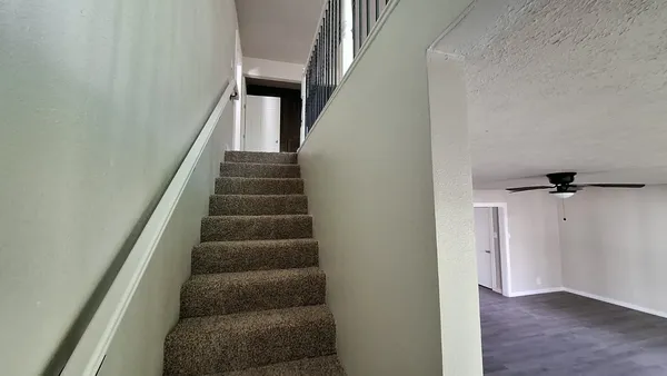 a view of a livingroom with a ceiling fan and window