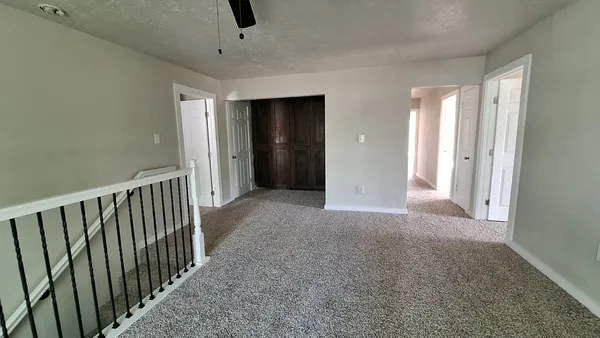 an empty room with mirror and door