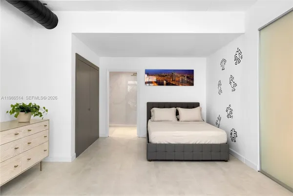 a bedroom with a bed and a potted plant