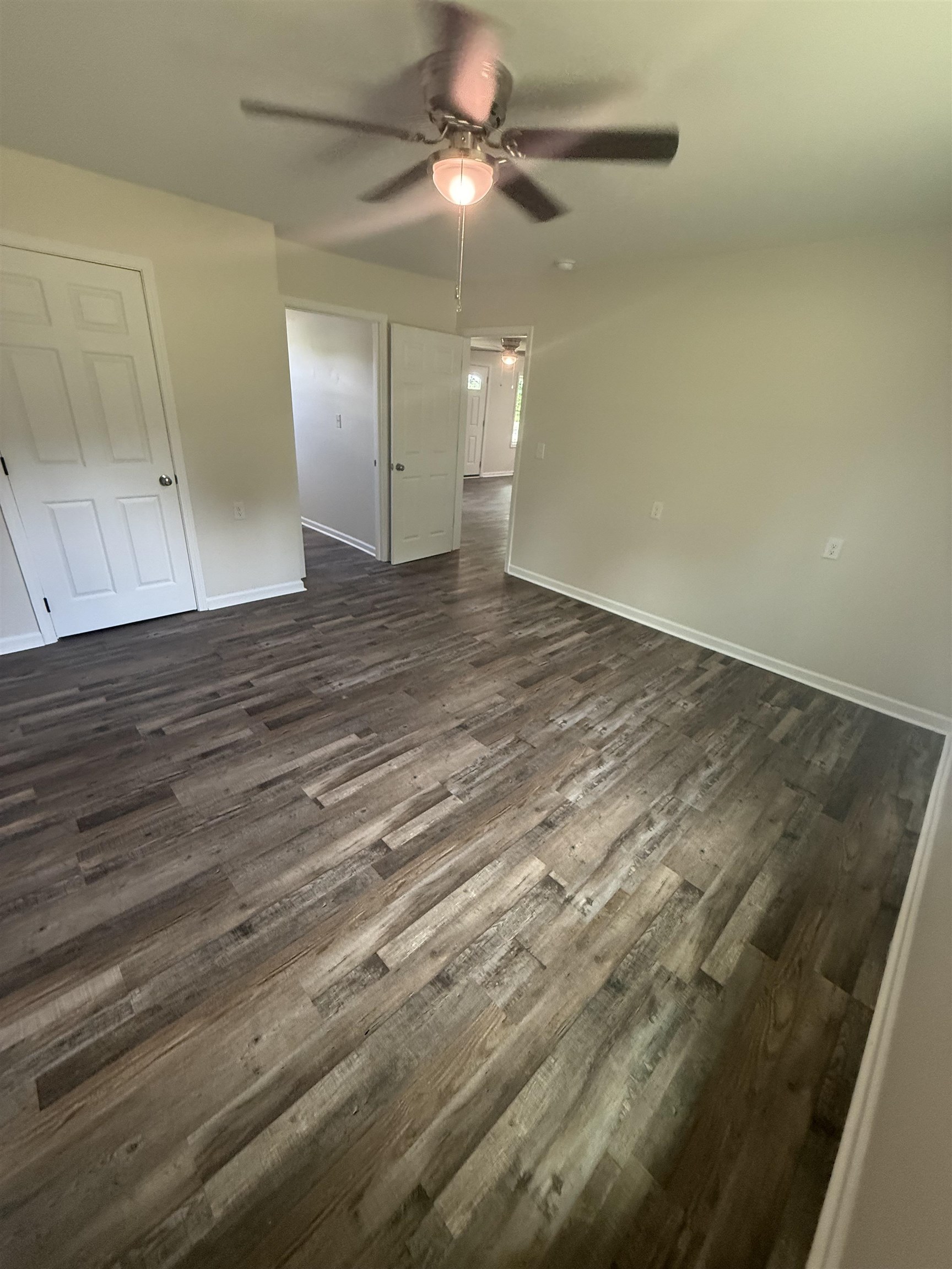 170 Leapwood Road Enville, TN 38332 - Photo 15 of 33 Spacious room featuring wood-finish flooring, light-toned wall paint, and a ceiling fan with integrated lighting