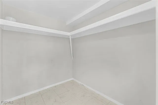 a utility room with cabinets washer and dryer