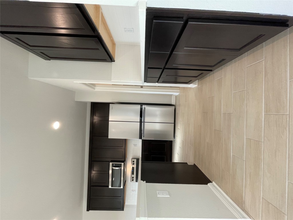 125 Old Stagecoach Road Jarrell, TX 76537 - Photo 14 of 31 a kitchen with stainless steel appliances a refrigerator and a stove top oven