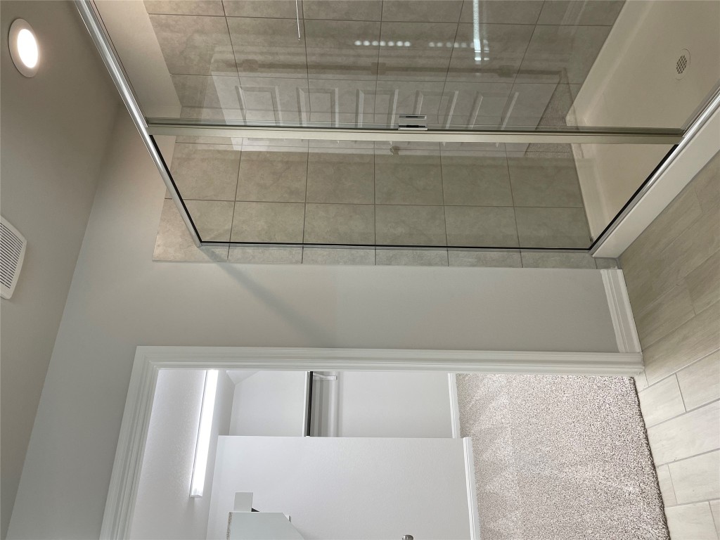 125 Old Stagecoach Road Jarrell, TX 76537 - Photo 22 of 31 a bathroom with a glass shower door