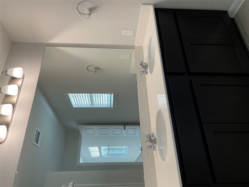 125 Old Stagecoach Road Jarrell, TX 76537 - Photo 26 of 31 a bathroom with a double vanity sink and mirror