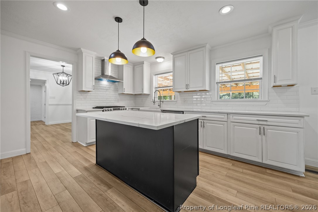 309 Cornith Road Pembroke, NC 28372 - Photo 17 of 49 a kitchen with stainless steel appliances granite countertop a sink a stove a refrigerator and white cabinets with wooden floor