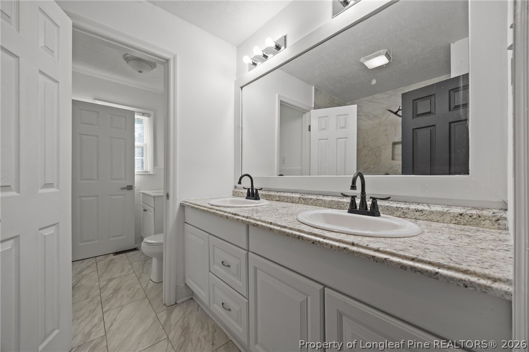309 Cornith Road Pembroke, NC 28372 - Photo 39 of 49 a bathroom with a granite countertop sink and a mirror