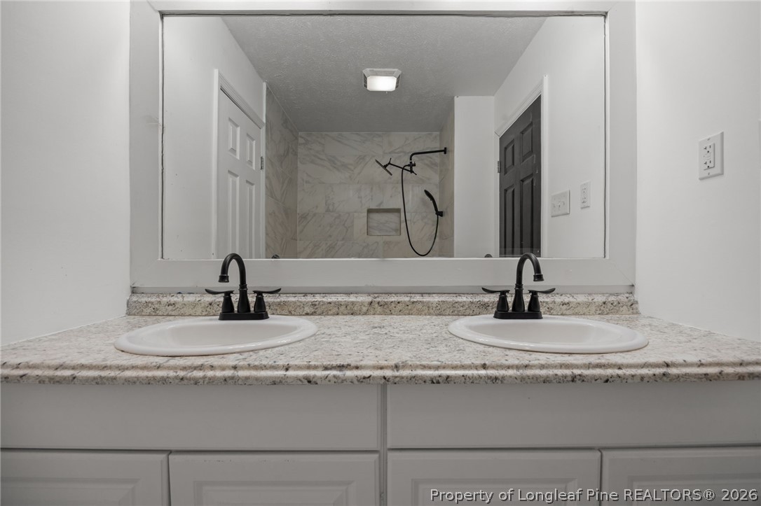 309 Cornith Road Pembroke, NC 28372 - Photo 40 of 49 a bathroom with a granite countertop sink and a mirror